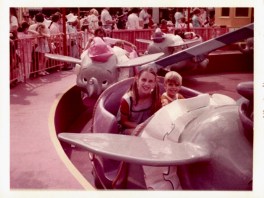Girl and boy on Dumbo flying elephant ride at Walt Disney World