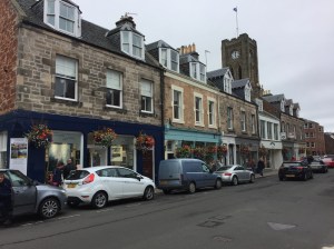 Row of 18th century stone houses and storefronts in Scotland