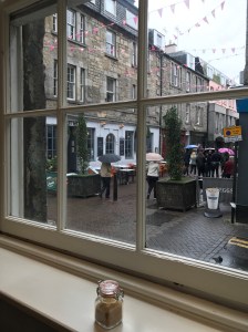 View of a pedestrian street from inside a coffee shop