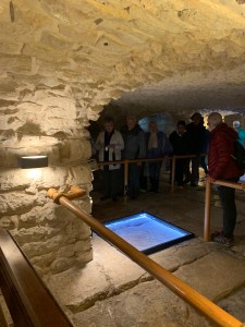 People standing in a dimly lit room with a low ceiling