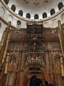 Ornate marble edifice in a rotunda under a domed ceiling covered with gold stars