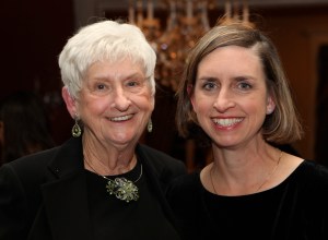 A mother and adult daughter in black tops