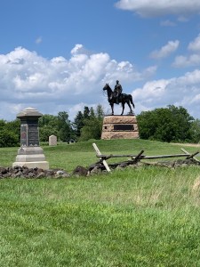 Statue of a man on a horse in a grassy field