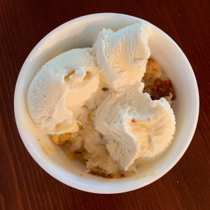 Bowl of Peach Cobbler and Ice Cream